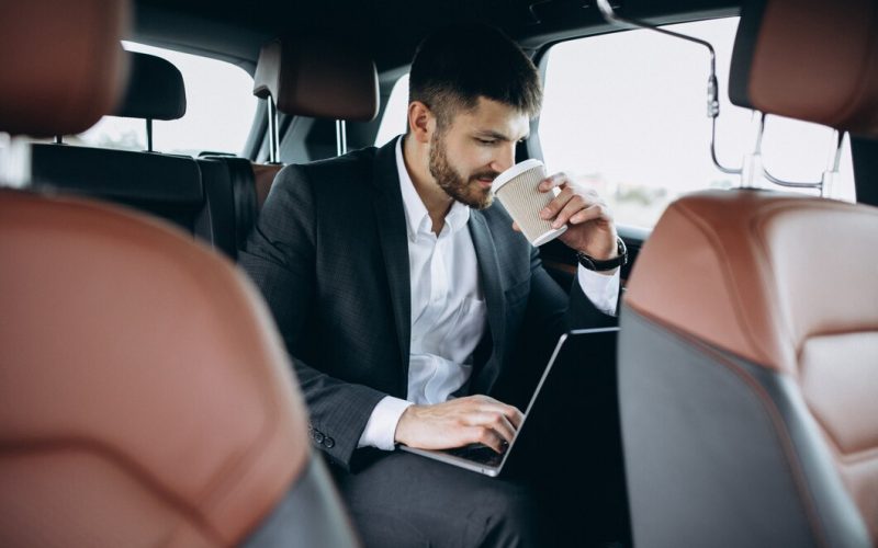 handsome-business-man-working-computer-car_1303-16419